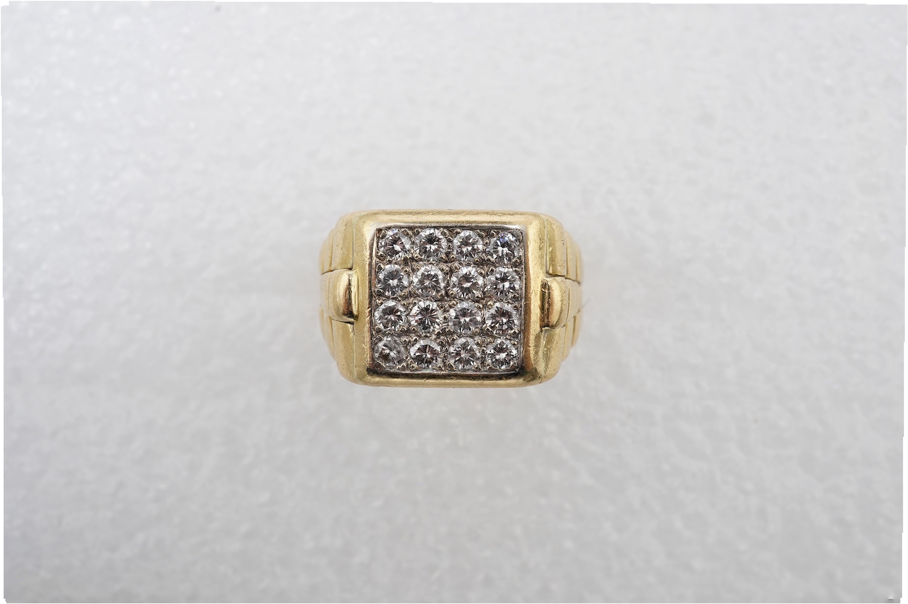 A gold and diamond signet ring